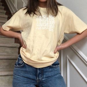 undefeated tee in pastel yellow color